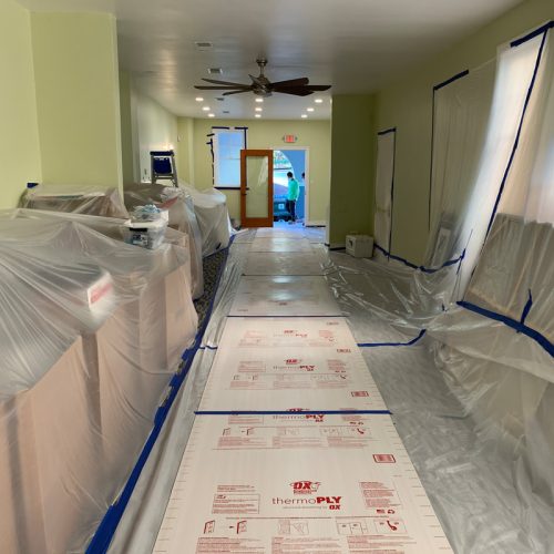 A hallway in a building covered in plastic sheeting